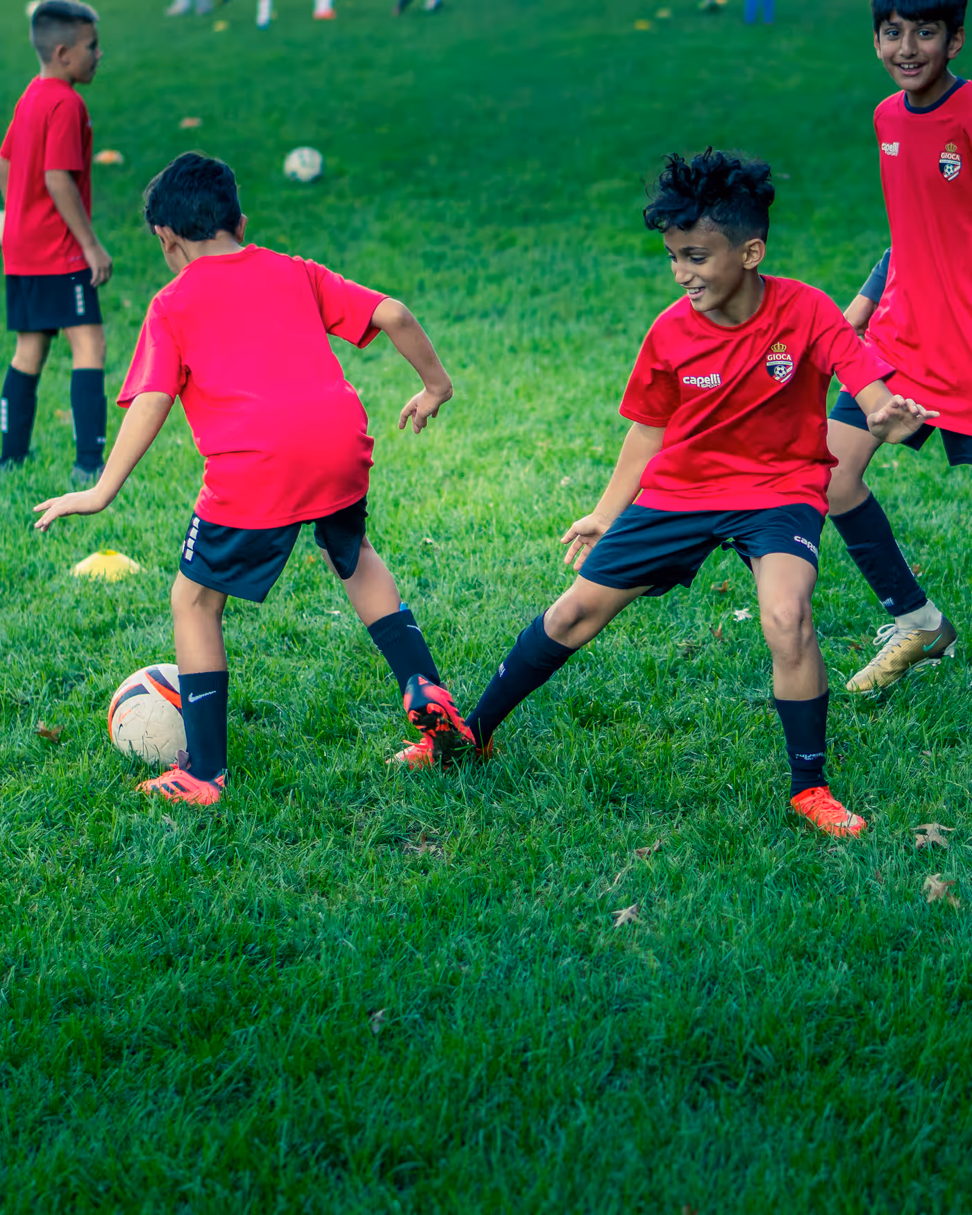 Gioca players in red training shirts competing one against one at training